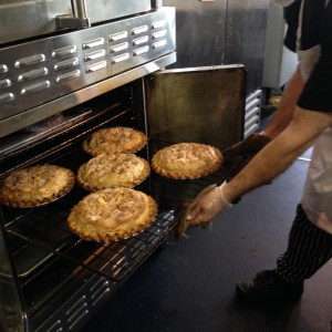 Our baker Marty pulls 5 apple pies from the oven 