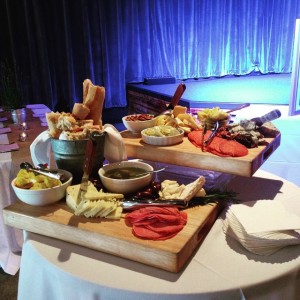 A huge display of local cheeses and cured meats at a rehearsal dinner
