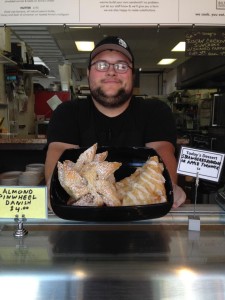 Devon holds today's featured desserts:  Almond Pinwheel Danish & Strawberry Rhubarb or Apple Turnovers