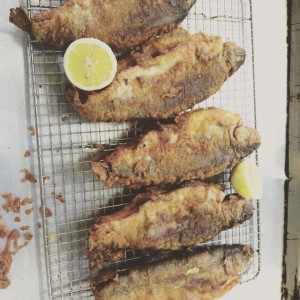 a pan of local fried trout with lemon 